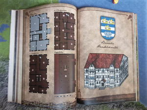 Die Seite aus dem Pen-and-Paper Buch zeigt dem Spielleiter das prachtvolle Anwesen des Brinaler Handelskontors in der Stadt Aran.