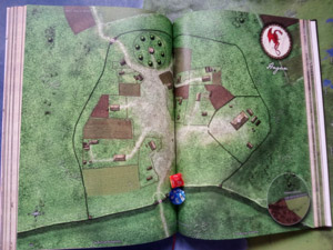Das aufgeschlagene Buch zeigt die Karte des Grenzortes Hagan und die Wallanlage Barrendwall im Königreich Barrendyn.